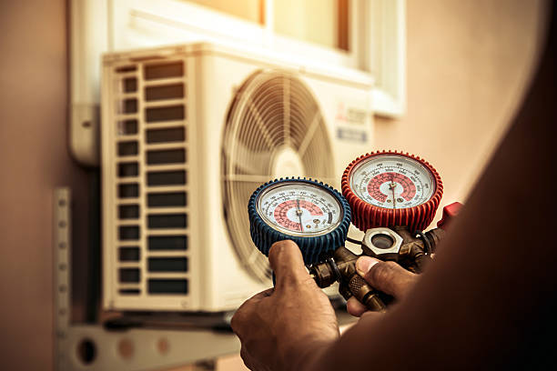 Professional Air Conditioning Service technician working in Monmouth, OR